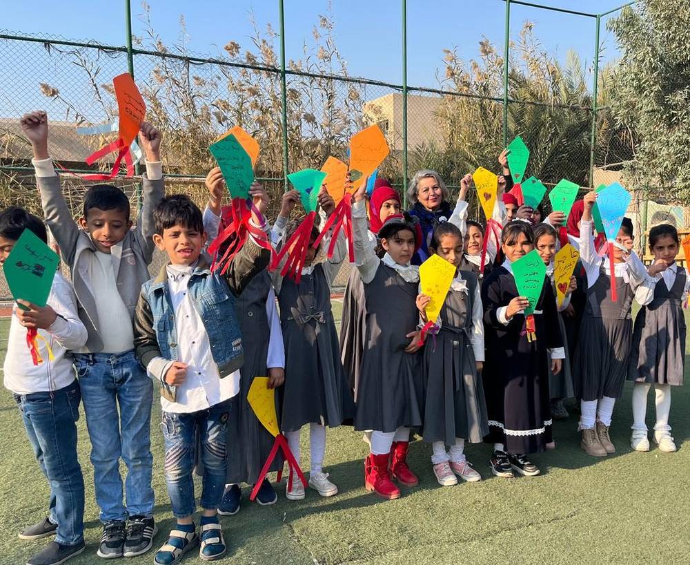 Children holding up kites they made