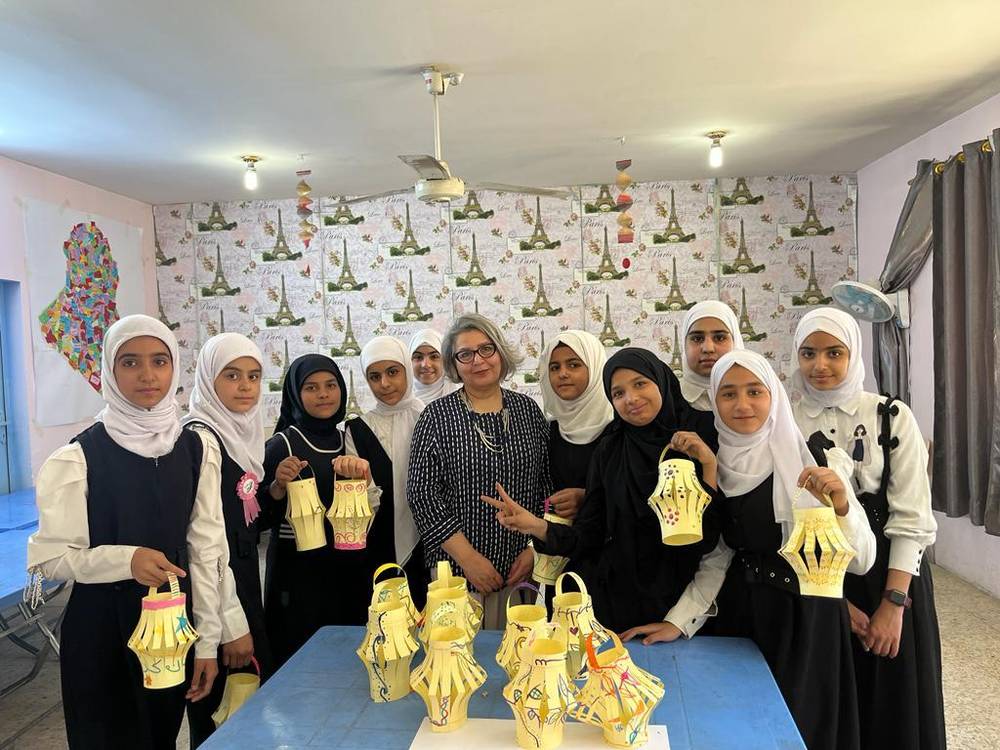 Girls holding paper Ramadan lanterns