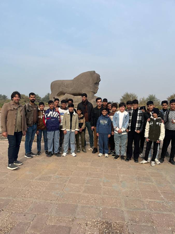 Boys in front of the Lion of Babylon