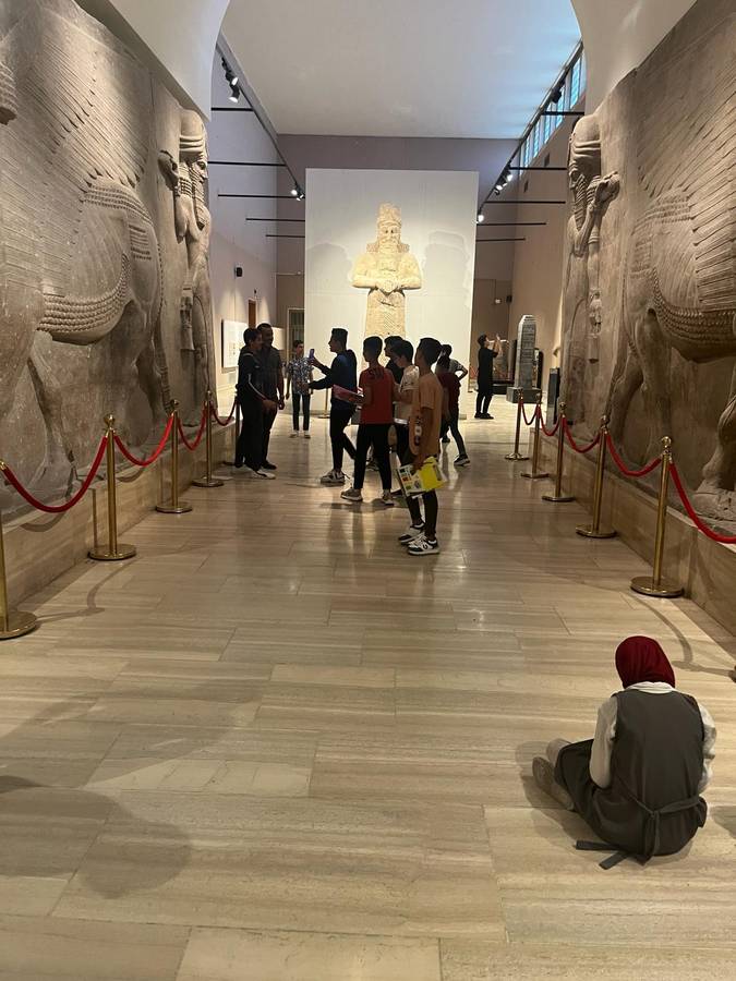 Children exploring the Assyrian gallery at the Iraq Museum