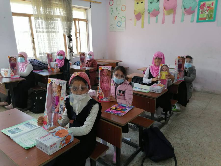 Girls at their desks with Eid presents