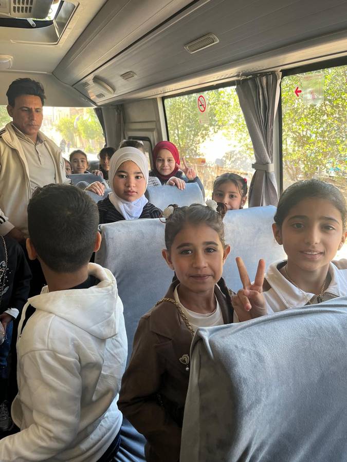 Children smiling on the school bus