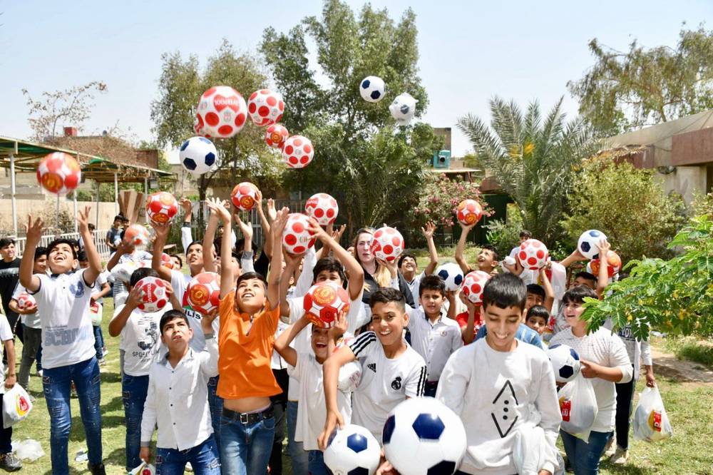 Boys cheering with new footballs